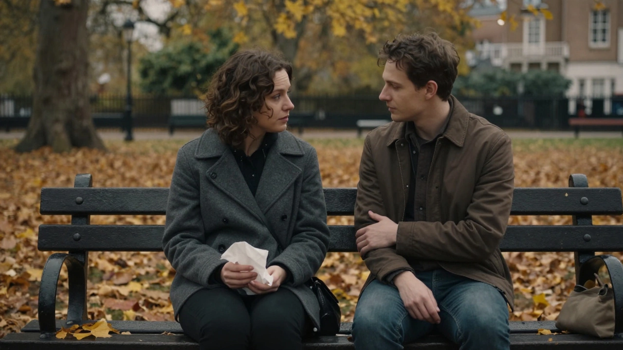 Two people sitting silently on a park bench in autumn, sharing a quiet moment of support.